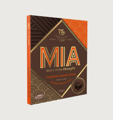Picture of the MIA ginger and cashew bar on a grey background. The packaging is brown with orange and gold trims.