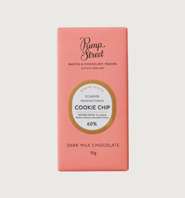 Picture of pump street's cookie chip bar on a grey background. The packaging is pink with a gold circle around the label