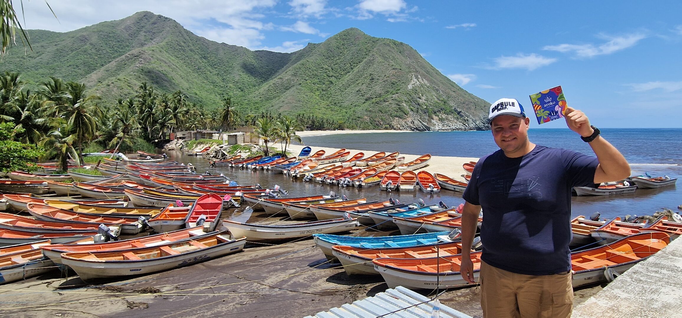 Johonny from aroko stood with a bar next to some boats