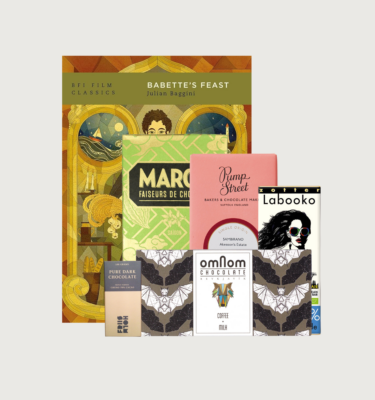Picture of our book and bar gift box for bebettes feast. The book is gold and brown and olive green, and the bars are placed in front of the book.