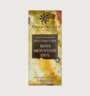 Picture of Choco del sol's Maya mountain bar on a grey background. The packaging is abstract, and is yellow, white, olive and red with a black label.