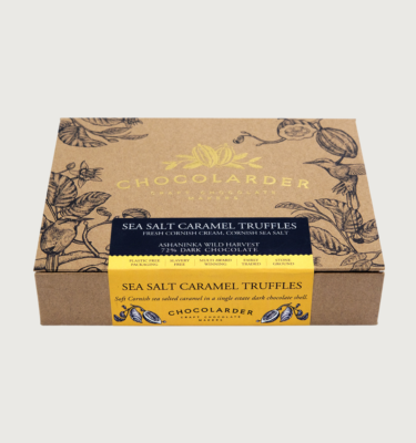Picture of chocolarder's sea salted caramel truffles on a grey background. The box is brown and covered in designs of cocoa pods, with a yellow label.