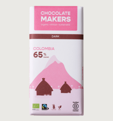 A chocolatemakers bar on a grey background. The bar is pink and brown with two huts snd a mountain