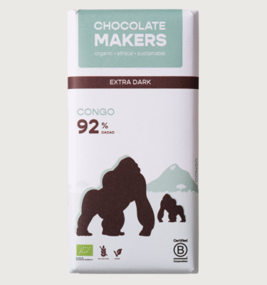 A bar from chocolatemakers on a grey background. the packaging is white, brown, and turquoise and features illustrations of two gorillas