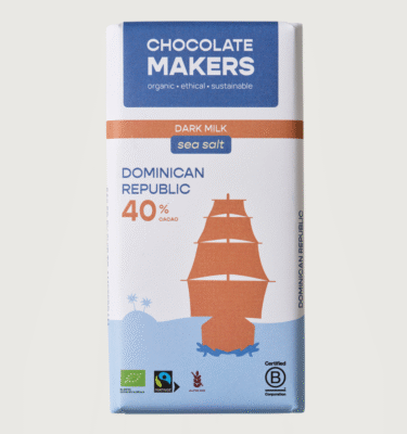 A chocolatemakers bar on a grey background. The packaging is white, blue and orange with a ship on it.