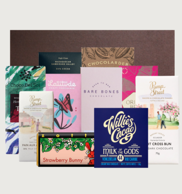 Easter Deluxe Box 2025 on a grey background. The bars are organised randomly in front of a brown box