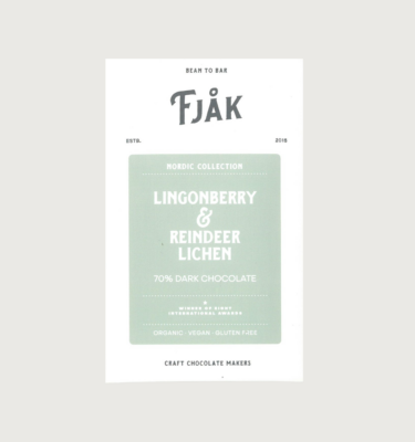 Fjak's Reindeer and Lingonberry bar on agrey background. The bar is white, with a sage green label and white writing