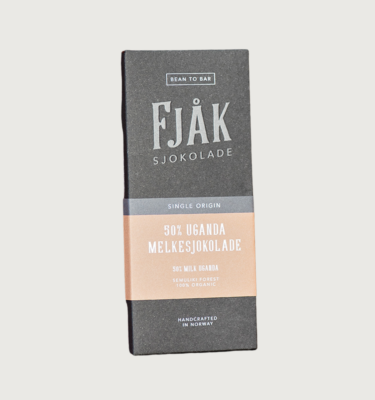 Picture of fjak's dark milk uganda bar on a grey background. The bar is grey, with a light brown label in the centre of the bar.