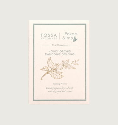 A fossa bar on a grey background. The packaging is white and green