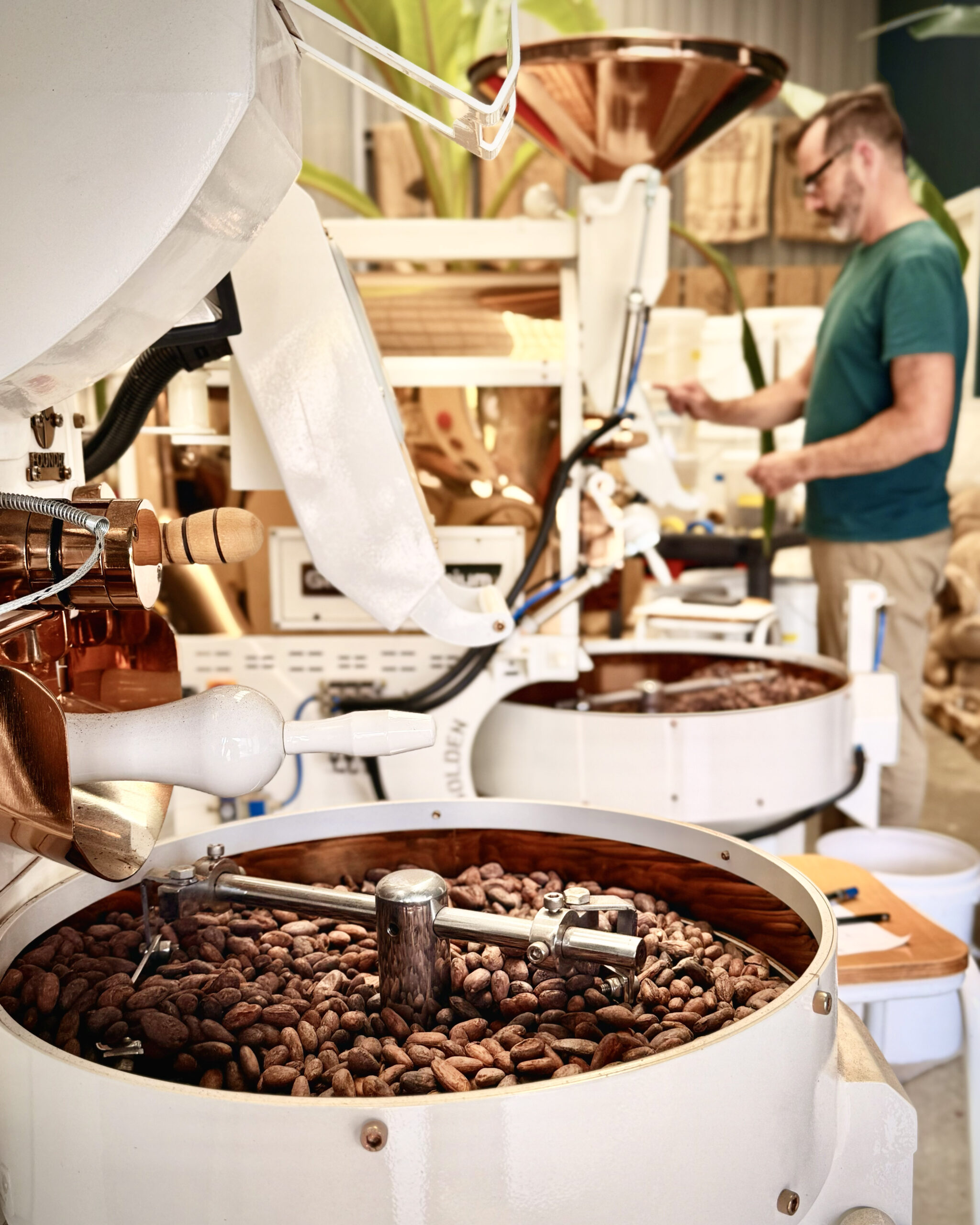 Chocolate churning in giant white buckets. 