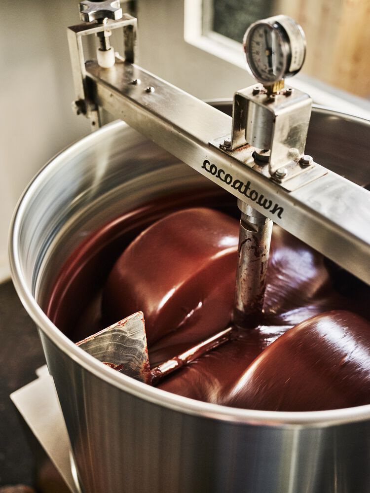A photo of a machine churning liquid chocolate