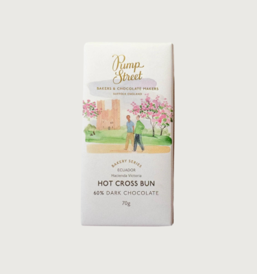 Picture of pump street's hot cross bun bar on a grey background. The bar is white, with a watercolour image of two people walking through the grounds of a castle, with cherry blossoms behind them.